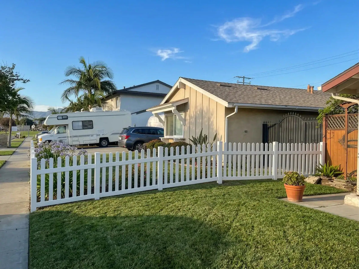 White vinyl picket fence installed at a home